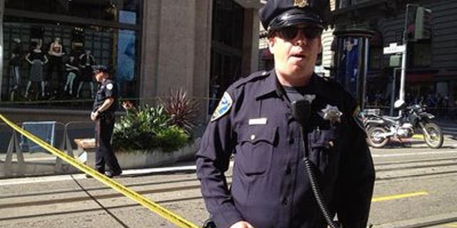 Oct. 17, 2013: A San Francisco police officer patrols an area near Union Square after a bomb square temporarily led to the evacuation of part of the city's downtown.