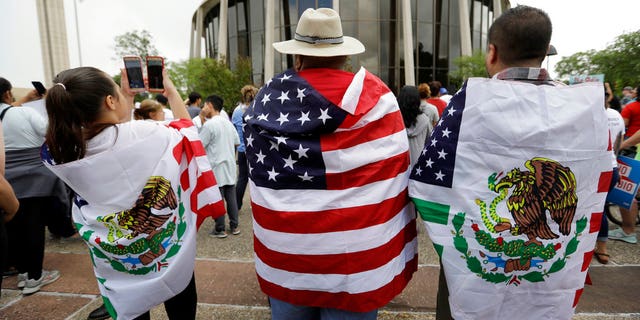 FILE - In this June 26, 2017, file photo, protesters outside the federal courthouse in San Antonio, Texas, take part in a rally to oppose a new Texas 