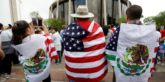 FILE - In this June 26, 2017, file photo, protesters outside the federal courthouse in San Antonio, Texas, take part in a rally to oppose a new Texas 