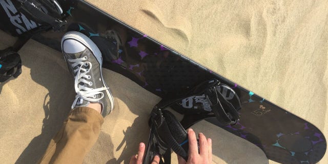 The straps evoke a snowboard, but you control a sandboard more like a surfboard.