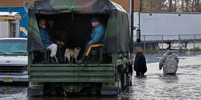 Military trucks, such as this one used earlier this week to rescue residents of a flooded Moonachie, NJ, well be sent to storm-ravaged areas of the Garden State on Election Day to be used as a make-shift polling station.