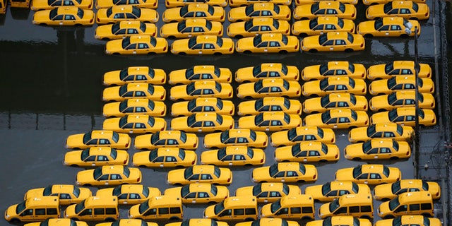 UNDATED: Flood damaged taxis in Weehawken, NJ, are among the thousands of cars that will need to be repaired or replaced in the coming weeks in the aftermath of superstorm Sandy.