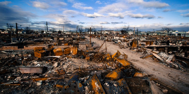 Clouds roll over destroyed homes after superstorm Sandy caused damage in the region of Breezy Point of Queens borough, New York.
