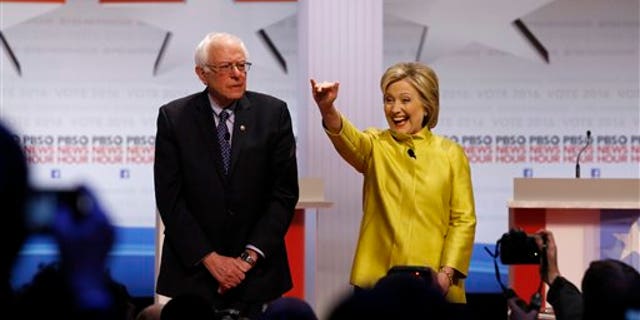 Democratic presidential candidates Sen. Bernie Sanders, I-Vt., and Hillary Clinton take the stage before a primary debate at the University of Wisconsin-Milwaukee, Feb. 11, 2016, in Milwaukee. (AP Photo/Tom Lynn)