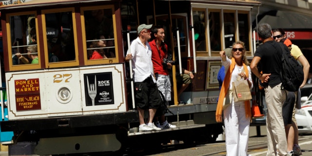 Sept. 1, 2010: Visitors wait to board a cable car in San Francisco's Union Square.