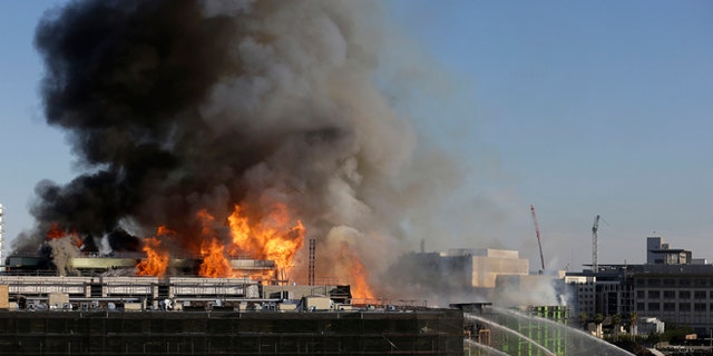 Mar. 11, 2014: Smoke rises from a fire burning in San Francisco.