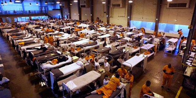 In this May 20, 2009 file photo, several hundred inmates crowd the gymnasium at San Quentin prison in San Quentin, Calif.