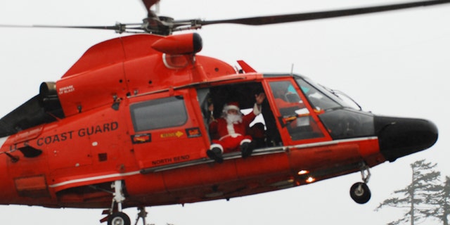 Coast Guard Master Chief Petty Officer Frank Allard arrives at the mall dressed as Santa in 2010.