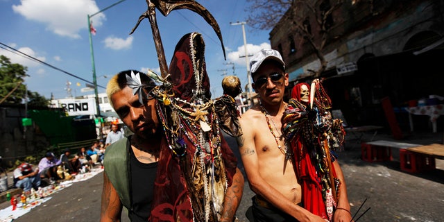 Followers of La Santa Muerte pose for a photograph in Tepito, Mexico City.