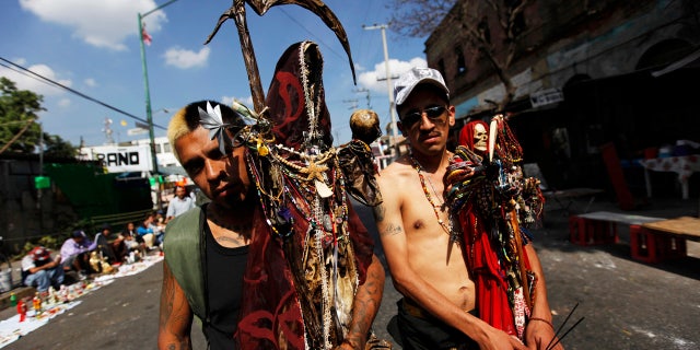 Followers of La Santa Muerte pose for a photograph in Tepito, Mexico City.