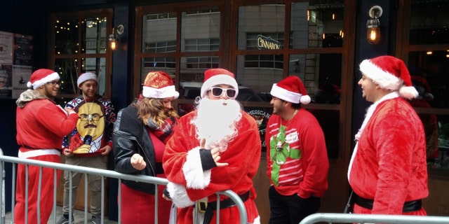 SantaCon revelers line up to enter a New York City tavern during last year's event, Dec. 10, 2016.