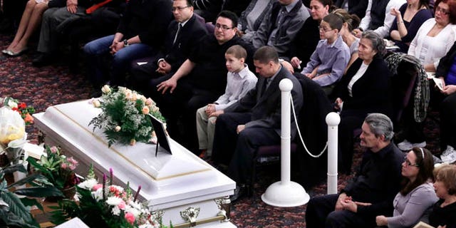 Feb. 15, 2013: Steven Sierra, husband of Sarai Sierra, upper center, with his son Silas Sierra, age 9, and Dennis Jimenez, second from right, father of Sarai Sierra, with his wife Betzaida Jimene, attend her funeral, at the Christian Pentecostal Church, in the Staten Island borough of New York.  The 33-year-old mother of two was killed while vacationing alone in Turkey. Her body was found in Istanbul, 12 days after she disappeared.