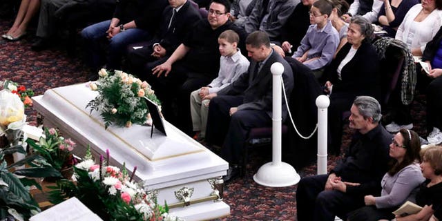 Feb. 15, 2013: Steven Sierra, husband of Sarai Sierra, upper center, with his son Silas Sierra, age 9, and Dennis Jimenez, second from right, father of Sarai Sierra, with his wife Betzaida Jimene, attend her funeral, at the Christian Pentecostal Church, in the Staten Island borough of New York. The 33-year-old mother of two was killed while vacationing alone in Turkey. Her body was found in Istanbul, 12 days after she disappeared.