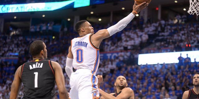 Apr 21, 2017; Oklahoma City, OK, USA; Oklahoma City Thunder guard Russell Westbrook (0) drives to the basket between Houston Rockets forward Trevor Ariza (1) and Houston Rockets guard Eric Gordon (10) during the fourth quarter in game three of the first round of the 2017 NBA Playoffs at Chesapeake Energy Arena. Mandatory Credit: Mark D. Smith-USA TODAY Sports