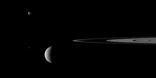 This still from the video "Outer Space" shows Saturn's rings and four of the giant planet's moons.