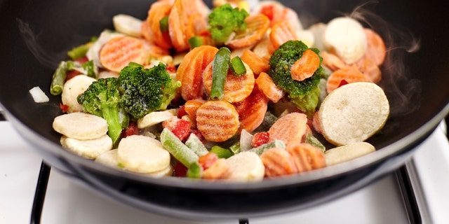 Closeup of frozen vegetables mix (broccoli, carrots, potatoes, peas)