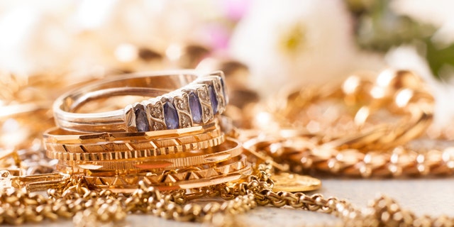shiny gold and silver jewelery on white table