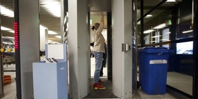 A passenger is screened inside a body scanner at Schiphol airport, Netherlands, Dec. 28. (AP Photo)