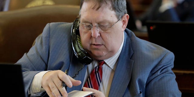 APRIL 26: Rep. Cecil Bell Jr., R-Magnolia works at his desk in the House Chamber at the Texas State Capitol, in Austin, Texas.