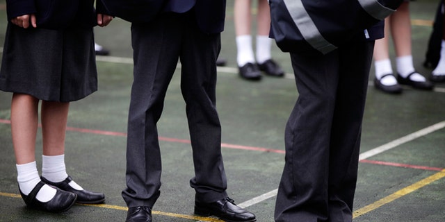 LONDON, ENGLAND - SEPTEMBER 09: Pupils wait for school buses in the playground after the Mayor of London opened the West London Free School on September 9, 2011 in London, England. The free school, one of the first semi-independent taxpayer-funded schools set up by groups of teachers and parents, is an 11-18 secondary school. It will teach a classical liberal syllabus, with latin compulsory to age 14 with its stated aim to be a "grammar school for all", MP Harold Wilson's original definition of a comprehensive school. (Photo by Matthew Lloyd/Getty Images)