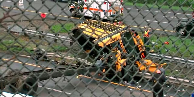 This image taken from WABC-TV video shows an overturned school bus after it collided with a dump truck, injuring multiple people, on Interstate 80 in Mount Olive, N.J., Thursday, May 17, 2018.