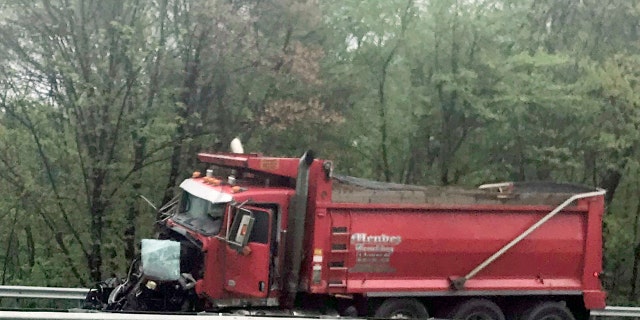 A dump truck sits near the scene after a collision with a school bus in Mount Olive, N.J., Thursday, May 17, 2018.