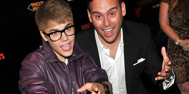 Justin Bieber and Scooter Braun (Photo by Stephen Lovekin/Getty Images for Dolce & Gabbana)