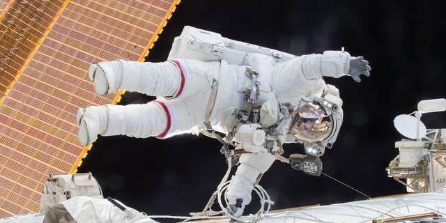 Expedition 46 Commander Scott Kelly on a Dec. 21, 2015 spacewalk, in which Kelly and Flight Engineer Tim Kopra successfully moved the International Space Station's mobile transporter rail car ahead of Wednesday's docking of a Russian cargo supply spacecraft.