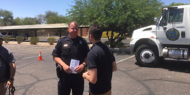 Scottsdale Police Sgt. Ben Hoster speaks to a member of the news media at the scene of a fatal shooting in Scottsdale, Ariz., on Saturday, June 2, 2018. (AP Photo/Paul Davenport)