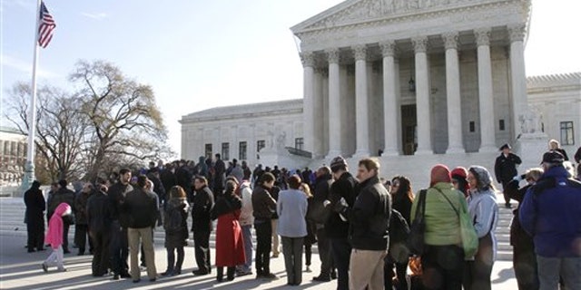 People line up outside the Supreme Court in Washington March 29 to attend a hearing on women employees against Wal-Mart.