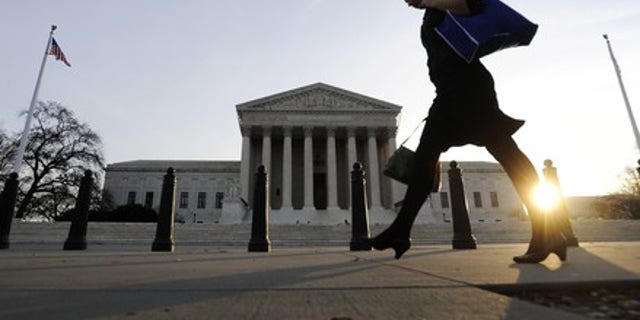 FILE -- A pedestrian walks past the US Supreme Court building in Washington. (REUTERS)