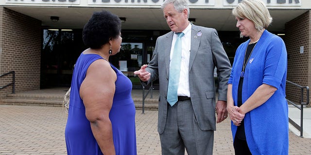 Republican candidate for U.S. Congress Ralph Norman, center, speaks with Gladys Jackson, left, as Norman's wife, Elaine, right, looks on at a polling place in South Carolina's 5th Congressional District in Rock Hill, S.C.