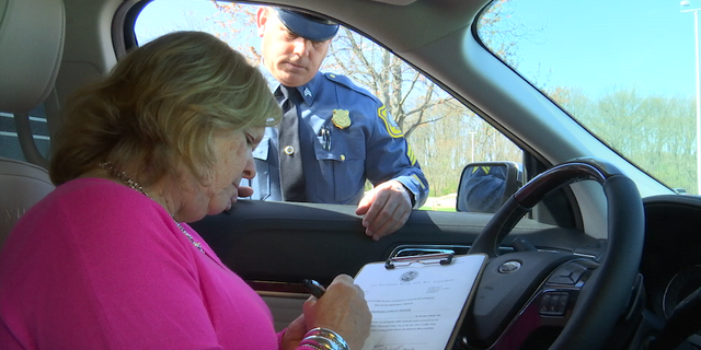 Customers like Jill Sheridan sign a waiver to have patrol officers take the wheel. (Left: Jill Sheridan, Driver / Right: Sgt. Thomas Nichols)