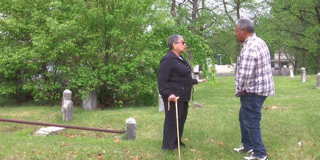 Yolanda Romero who serves on the Mount Peace Cemetery Association board speaks with volunteer.