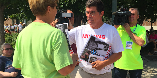 Rob Tibbetts, Mollie's father, hands out posters in search for his missing daughter.