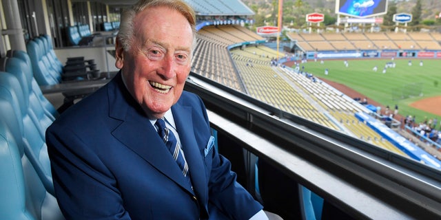 Sept. 20, 2016: Hall of Fame broadcaster Vin Scully poses for a photo prior a baseball game between the Los Angeles Dodgers and the San Francisco Giants in Los Angeles. His final game at Dodger Stadium - where he has described nearly 5,000 games over the years - will be Sunday against the Rockies.