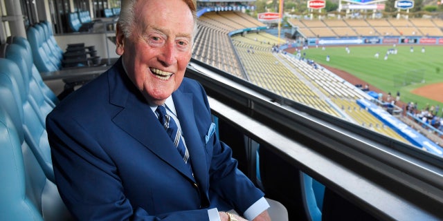 Sept. 20, 2016: Hall of Fame broadcaster Vin Scully poses for a photo prior a baseball game between the Los Angeles Dodgers and the San Francisco Giants in Los Angeles. His final game at Dodger Stadium - where he has described nearly 5,000 games over the years - will be Sunday against the Rockies.