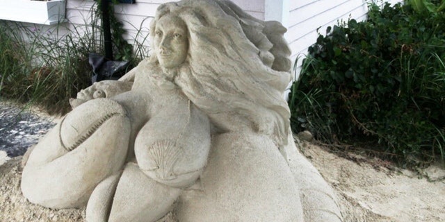 This July 7, 2016 photo shows the mermaid sand sculpture in front of Salty's Seafood Restaurant in West Yarmouth, Mass. Here, the sand sculpture is under a small tent enclosure outside the restaurant and is part of a larger collection of sculptures throughout Yarmouth.