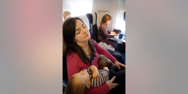 Mother and children sleeping on the plane