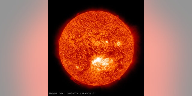 This image from the Solar Dynamics Observatory (SDO) shows the sun at 12:45 PM EDT on July 12, 2012 during an X1.4 class flare. The image is captured in the 304 Angstrom wavelength, which is typically colorized in red and shows temperatures in