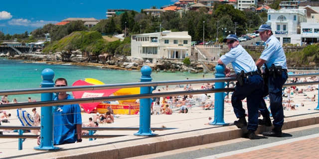 Two police officers watch over the beach at Coogee, Sydney. A heightened police presence was seen on NSW beaches following an event known as the 2005 Cronulla riots which were racialy linked.