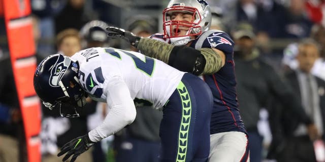 FOXBOROUGH, MA - NOVEMBER 13: New England Patriots tight end Rob Gronkowski takes a big hit from Seattle Seahawks player Earl Thomas during second quarter action. The New England Patriots host the Seattle Seahawks at Gillette Stadium in Foxborough, Mass., on Nov. 13, 2016. (Photo by Jim Davis/The Boston Globe via Getty Images)