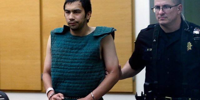 June 6, 2014: Shooting suspect Aaron Ybarra, left, is led in chains to a court hearing at a King County Jail in Seattle.