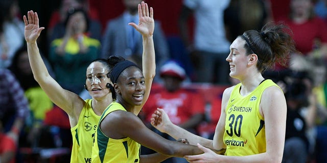 Seattle Storm players (from left) Sue Bird, Jewell Loyd and Breanna Stewart celebrate during the first half of Game 3 of the WNBA Finals Wednesday night in Fairfax, Va.