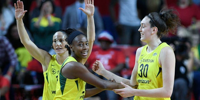 Seattle Storm players (from left) Sue Bird, Jewell Loyd and Breanna Stewart celebrate during the first half of Game 3 of the WNBA Finals Wednesday night in Fairfax, Va.