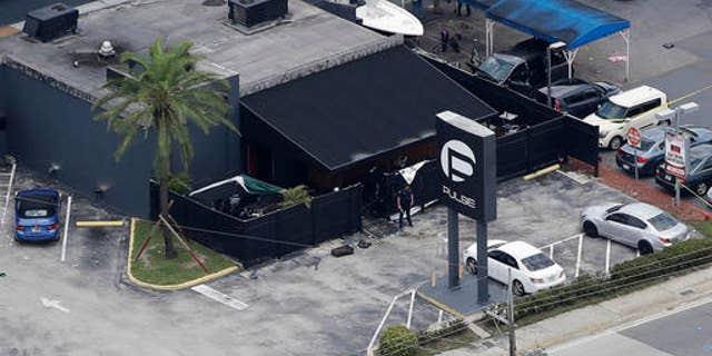 Law enforcement officials at the Pulse gay nightclub in Orlando, Florida, after a mass shooting.