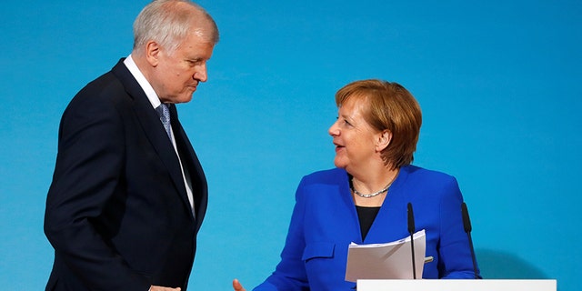 Interior Minister Horst Seehofer, seen here with Chancellor Angela Merkel, has promised a tougher line on migration.
