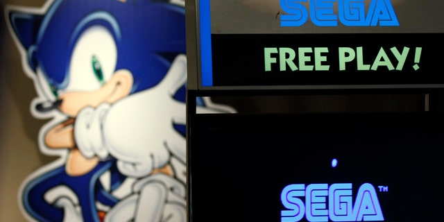 File photo: The Sonic the Hedgehog character is seen behind a video game screen showing a Sega Corp logo at a game arcade in Tokyo June 20, 2011. (REUTERS/Kim Kyung-Hoon)