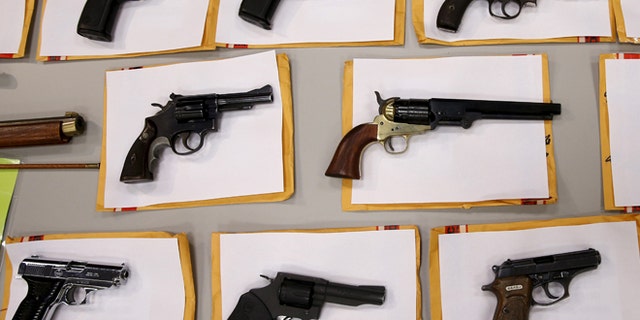 Guns seized on display at the Chicago Police Department Aug. 31, 2015.    