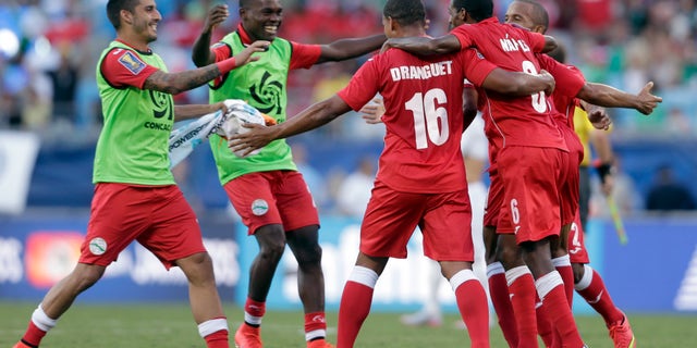 Cuba players celebrate after a CONCACAF Gold Cup soccer match against Guatemala in Charlotte, N.C., July 15, 2015.